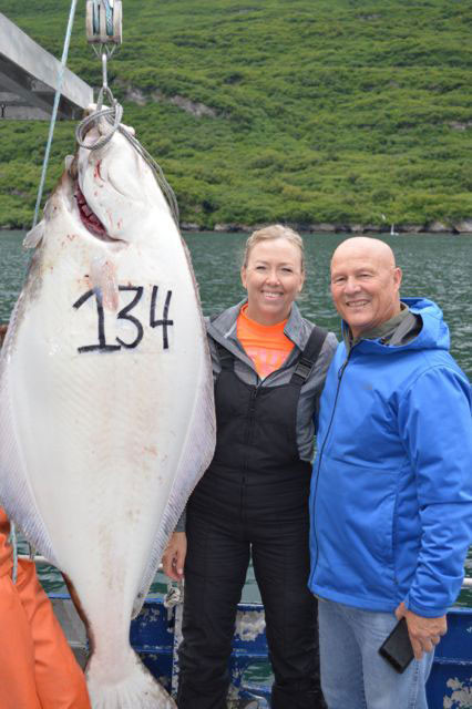 A happy couple displays their 134 Halibut catch