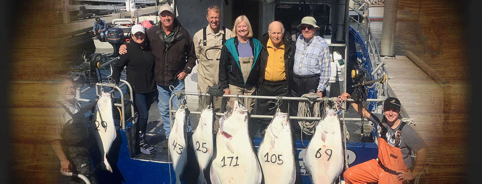 A group of fishermen display their halibut catch