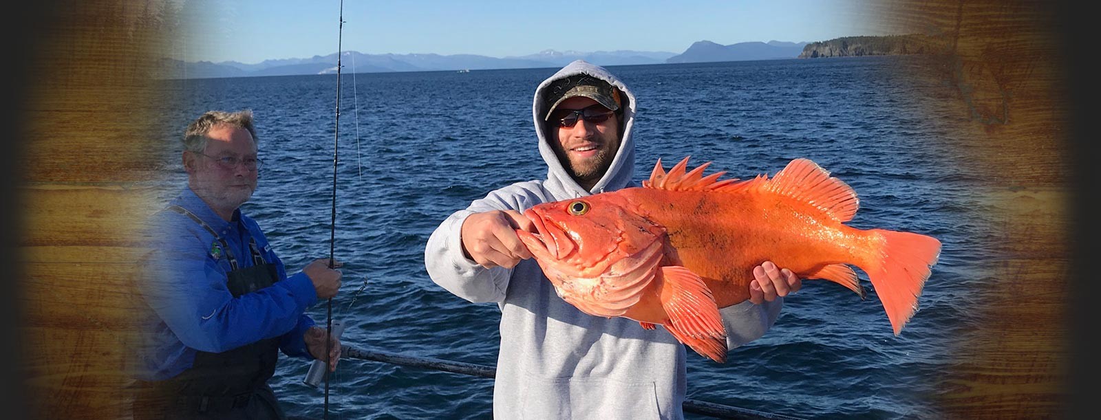 Smiling man holding yelloweye fish